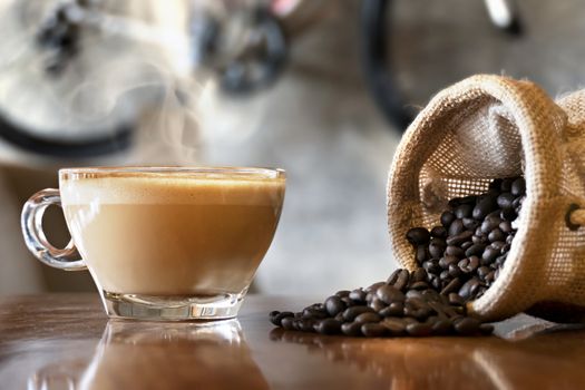 Cup of hot coffee latte on wood table in restaurant