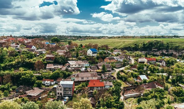 Landscape summer sunny view of a small village in the valley. Kamenets Podolsky. Ukraine.