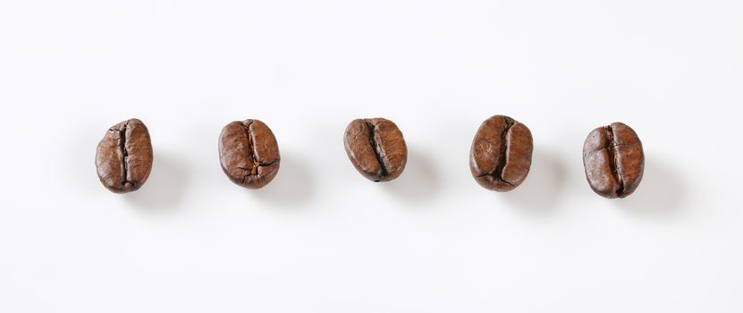 Roasted coffee beans in a row