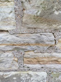 Old stone wall with holes texture background.