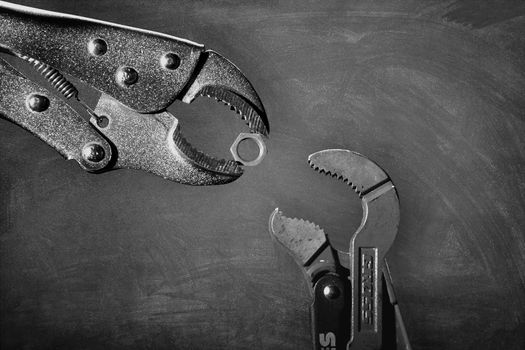 Ukraine, Kyiv, 09,13,2019 Creative image of plumbing wrenches as birds on gray background. Black and white unusual bird story. Editorial use only