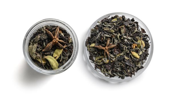 Green tea with aromatic additives. Top view on white background.