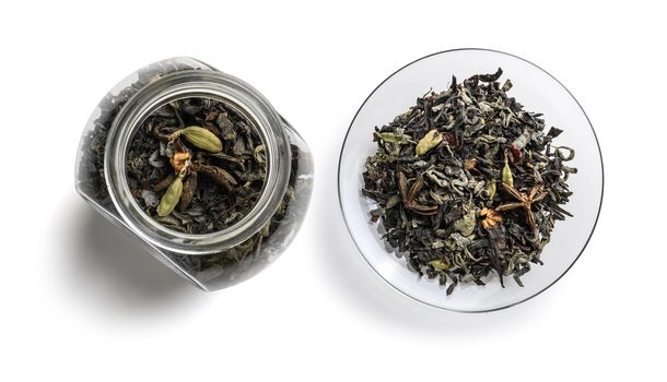 Green tea with aromatic additives. Top view on white background.