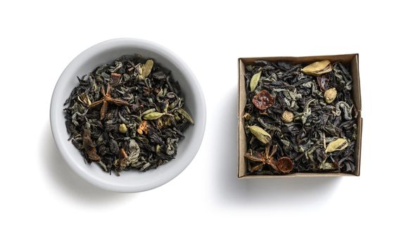 Green tea with aromatic additives. Top view on white background.