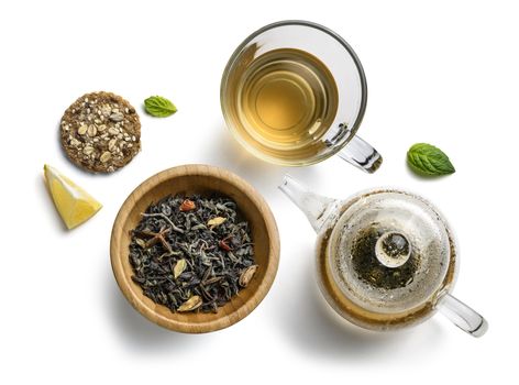 Green tea with natural aromatic additives and accessories. Top view on white background.