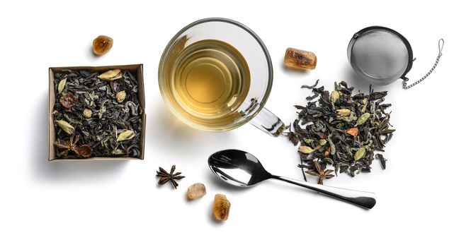 Green tea with natural aromatic additives and accessories. Top view on white background.