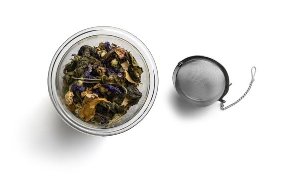Green tea with natural aromatic additives. Top view on white background.