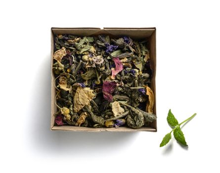 Green tea with natural aromatic additives. Top view on white background.