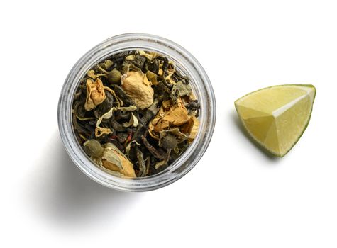 Green tea with natural aromatic additives. Top view on white background.