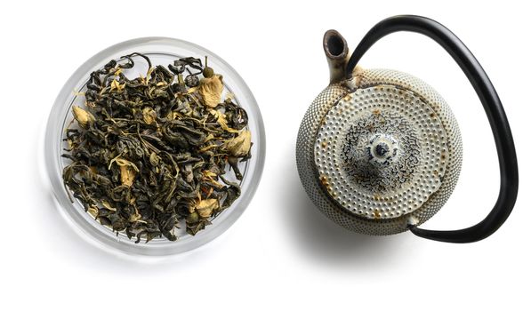 Green tea with natural aromatic additives. Top view on white background.