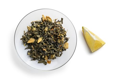 Green tea with natural aromatic additives. Top view on white background.