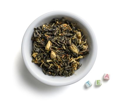 Green tea with natural aromatic additives. Top view on white background.