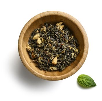 Green tea with natural aromatic additives. Top view on white background.