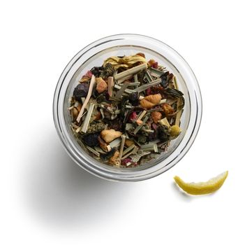 Green tea with natural aromatic additives. Top view on white background.