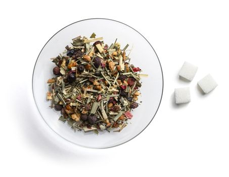 Green tea with natural aromatic additives and sugar. Top view on white background.