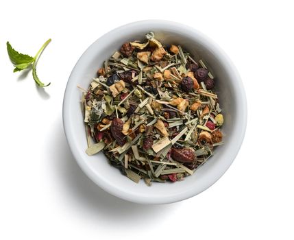 Green tea with natural aromatic additives. Top view on white background.