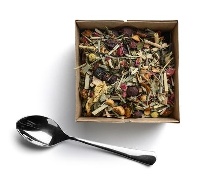 Green tea with natural aromatic additives. Top view on white background.