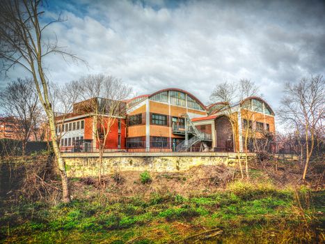 A colorful abandoned factory warehouse building exterior .