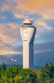 Control tower at international airport with private turbo prop plane landing