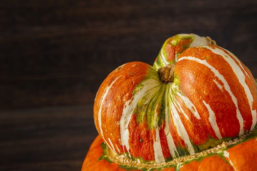 top part of a turban squash against a wood background