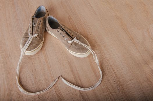 Blue lovely used sneakers on wooden desk