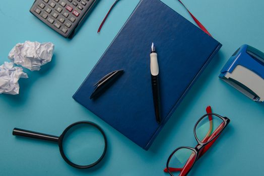 Desk with Tools and Notebook office desk on blue background