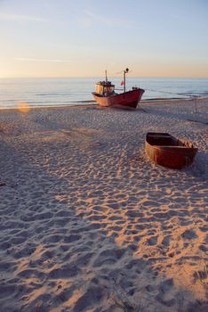 fisherman boats at sunrise time on the beach in summer