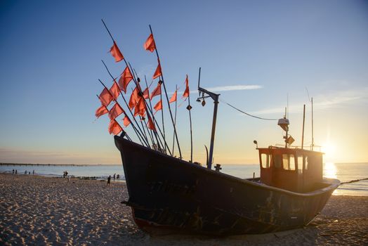 fisherman boats at sunrise time on the beach in summer