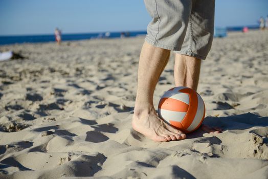 man playing soccer on beach with dribble skill and ball on vacation