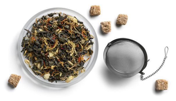 Green tea with natural aromatic additives and sugar. Top view on white background.