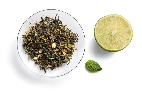 Green tea with natural aromatic additives. Top view on white background.