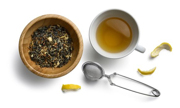 Green tea with natural aromatic additives and a Cup of tea. Top view on white background.