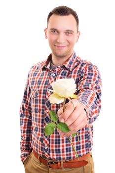 Portrait of a smiling handsome young man handing out a white rose flower to the camera, isolated on white background. Valentine's day, romance, love concept.