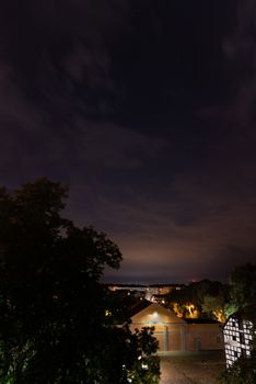 Szczecin. Night view from across the river to the illuminated historic center. Odra river. Chrobry embankments in Szczecin