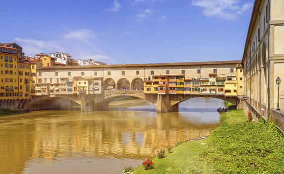 Medieval stone bridge Ponte Vecchio over Arno river in Florence by day, Tuscany, Italy