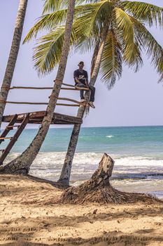 PLAYA LIMON, DOMINICAN REPUBLIC 28 DECEMBER 2019: Dominican man looks at the sea