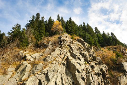 View from Transfagarasan road down to a rock. It is a paved mountain road crossing the southern section of the Carpathian Mountains of Romania. It has national-road ranking and is the second-highest paved road in the country after the Transalpina.