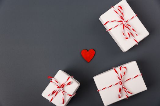 Valentine's day Concept, flat lay top view, White Gift Box and Red Heart on Gray background with copy space for your text