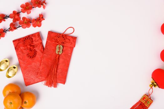 Chinese new year festival concept, flat lay top view, Happy Chinese new year with Red envelope and gold ingot (Character "FU" means fortune, blessing) on white background with copy space for text