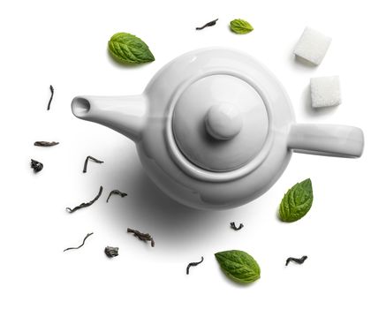 Teapots and tea leaves on a white background. The view from the top.