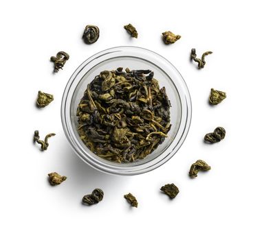 Green tea lies in a circle on a white background. The view from the top.