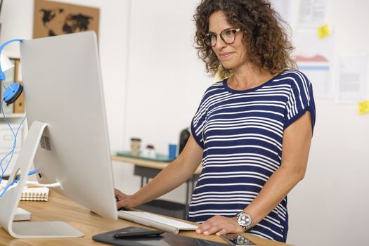 Middle aged woman at office making a phone call