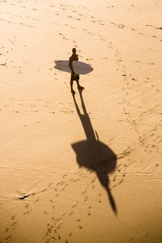 Top view of a surfer on the beach
