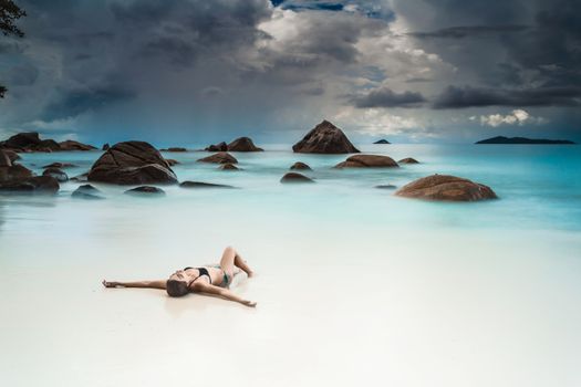 Woman relaxing at the tropical beach of Anze Lazio, Seychelles