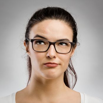 Portrait of a beautiful young woman with a thinking expression