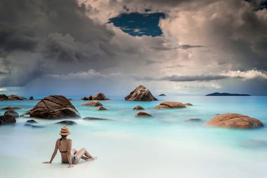 Woman relaxing at the tropical beach of Anze Lazio, Seychelles