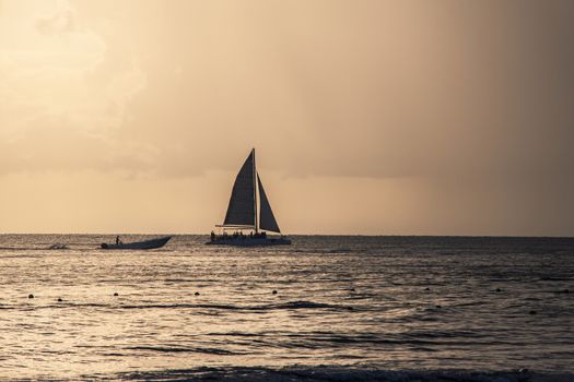 Dominica sunset with boat an sea at horizon