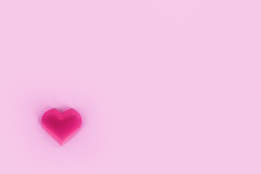 Valentine's day silk heart on pink paper background, love concept