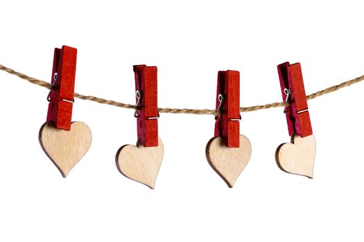 Red clothes pegs and wooden hearts on rope isolated on white background. Valentines day concept