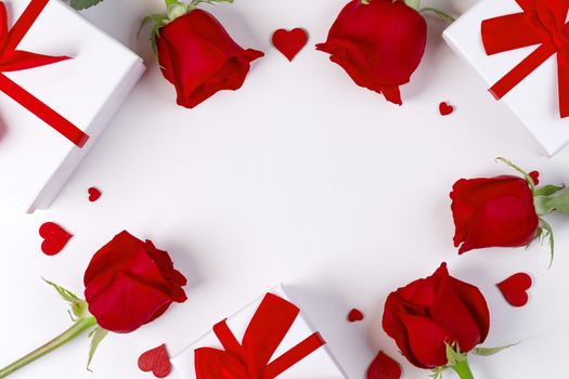 Red rose flowers gifts and red hearts composition on white background top view with copy space. Valentine's day, birthday, wedding, Mother's day concept. Copy space